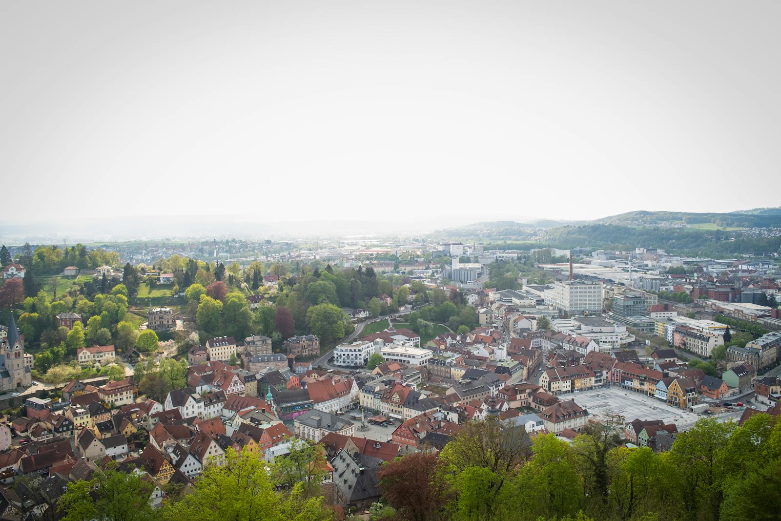Explore the historic charm of Kulmbach, Germany, with its scenic cityscape and lush greenery from above.